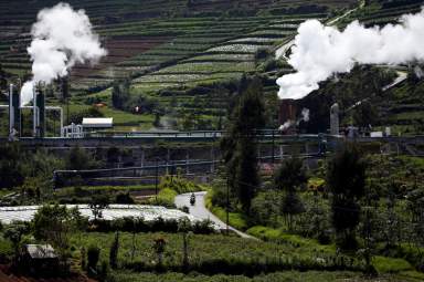 Local rides a motorbike on a road near geothermal power station unit owned by PT. Geo Dipa Energi (Persero) at Dieng mountain area in Banjarnegara