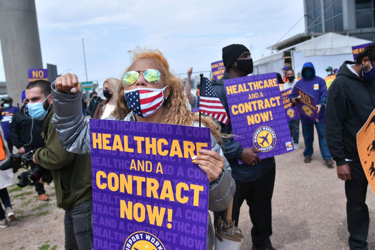 Members of Local BJ 32 protest outside JFK airport.