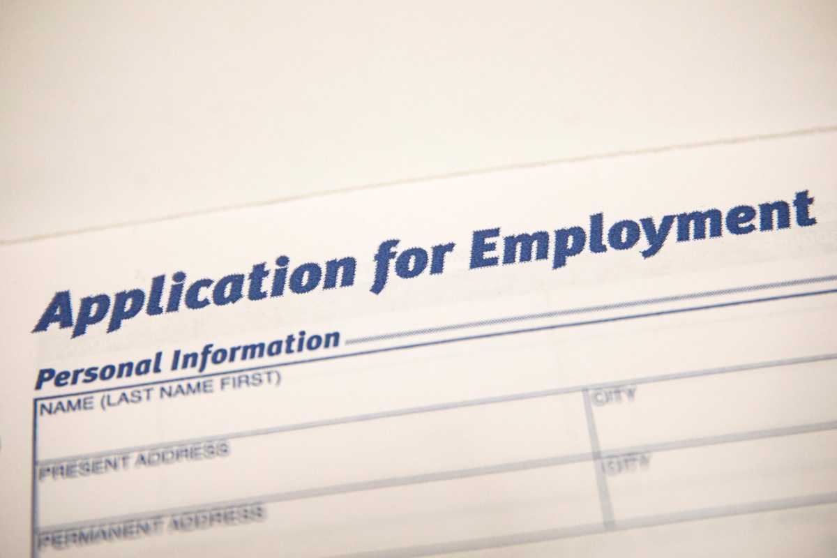 An employment application form is displayed during a restaurant job career fair in New York