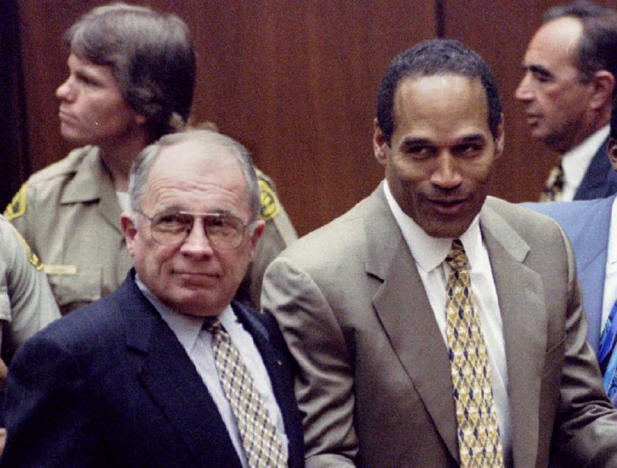 FILE PHOTO: Defendant OJ Simpson reacts after court clerk announces that Simpson was found not guilty