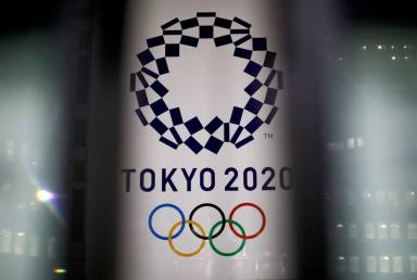 FILE PHOTO: The logo of Tokyo 2020 Olympic Games is seen through signboards, in Tokyo