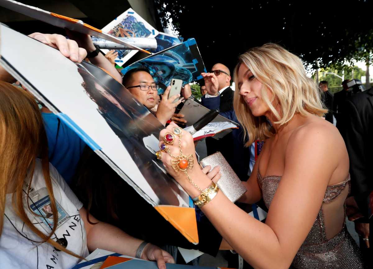 FILE PHOTO: Cast member Scarlett Johannsson signs autographs on the red carpet at the world premiere of the film “The Avengers: Endgame” in Los Angeles