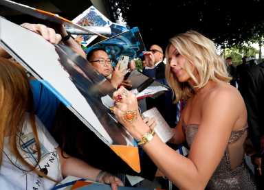 FILE PHOTO: Cast member Scarlett Johannsson signs autographs on the red carpet at the world premiere of the film “The Avengers: Endgame” in Los Angeles