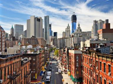 Cityscape of lower Manhattan with a blue sky