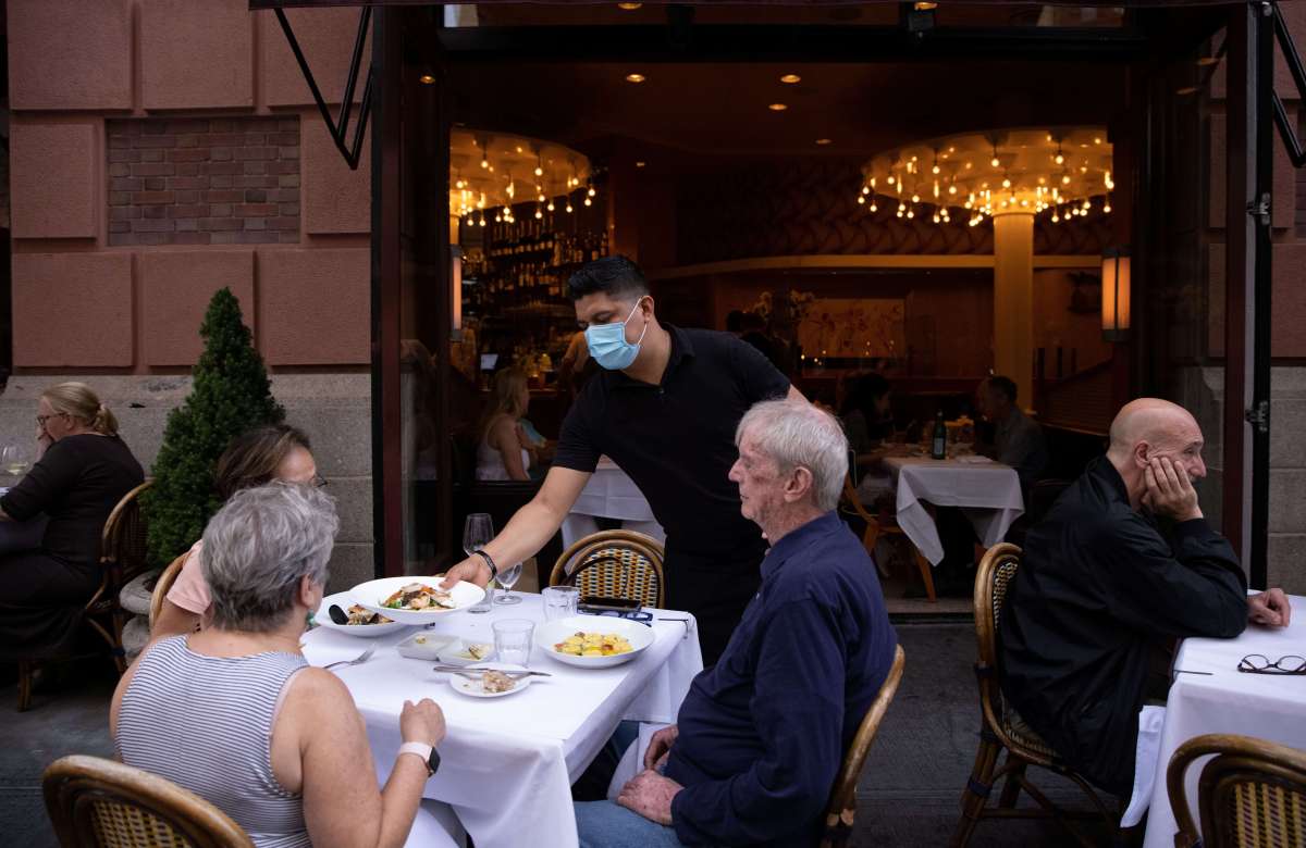 People eat at a restaurant in Manhattan, New York