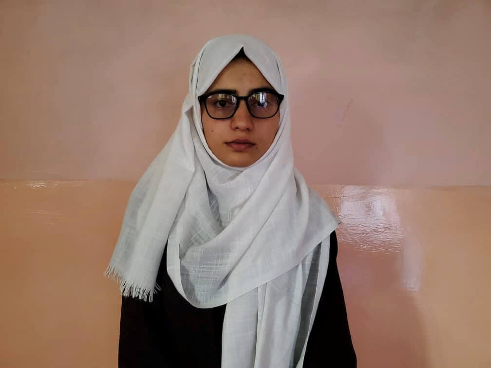 Salgy poses for a photo after topping Afghanistan’s university entrance exams, in Kabul