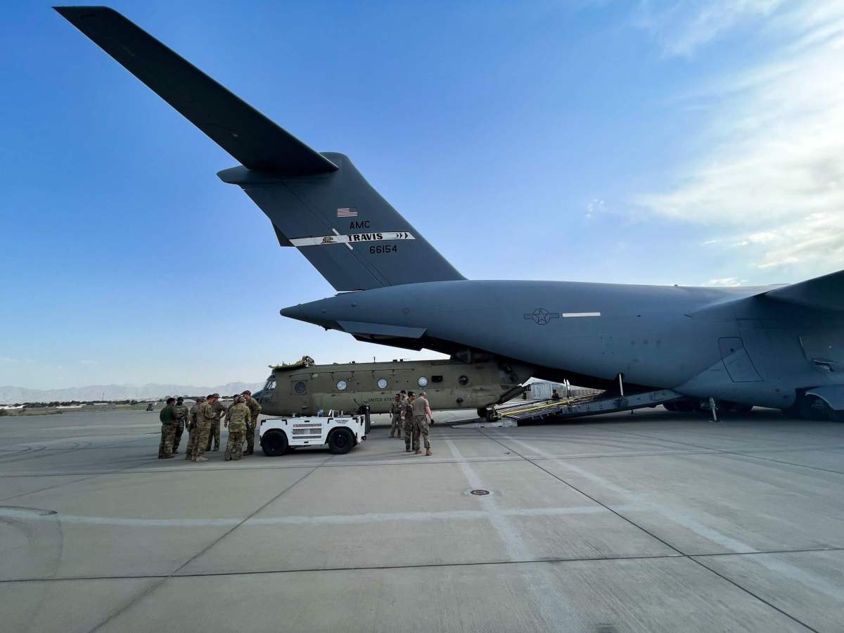 A CH-47 Chinook is loaded onto a U.S. Air Force C-17 Globemaster III at Hamid Karzai International Airport in Kabul