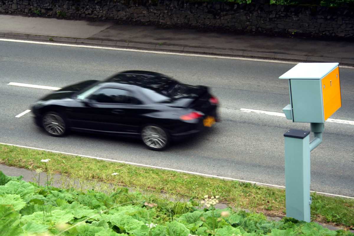 Car going past a speed camera on a street