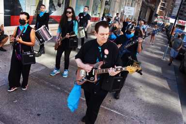 Patrick Grant leading “Tilted Axes” up Astor Place