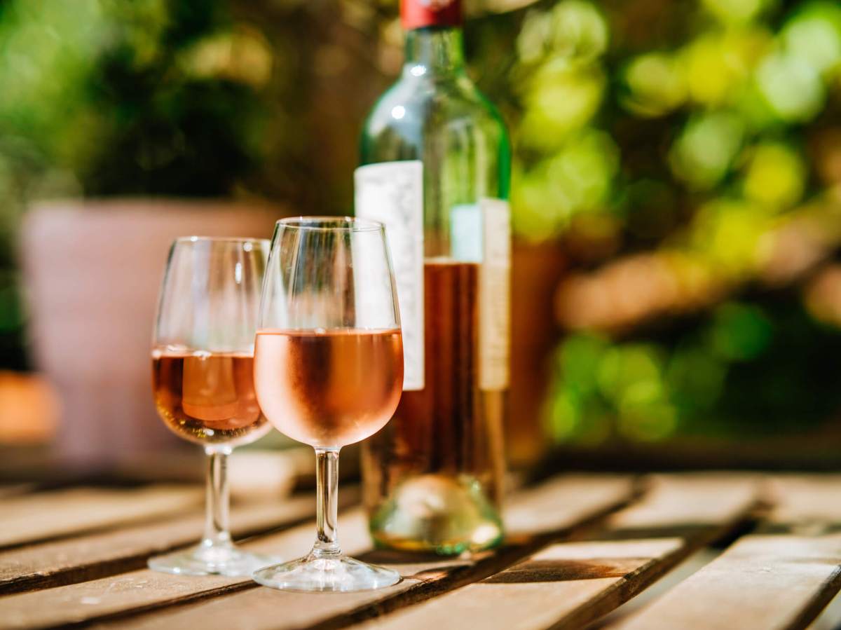 Glass of wine on a table in sunlight.