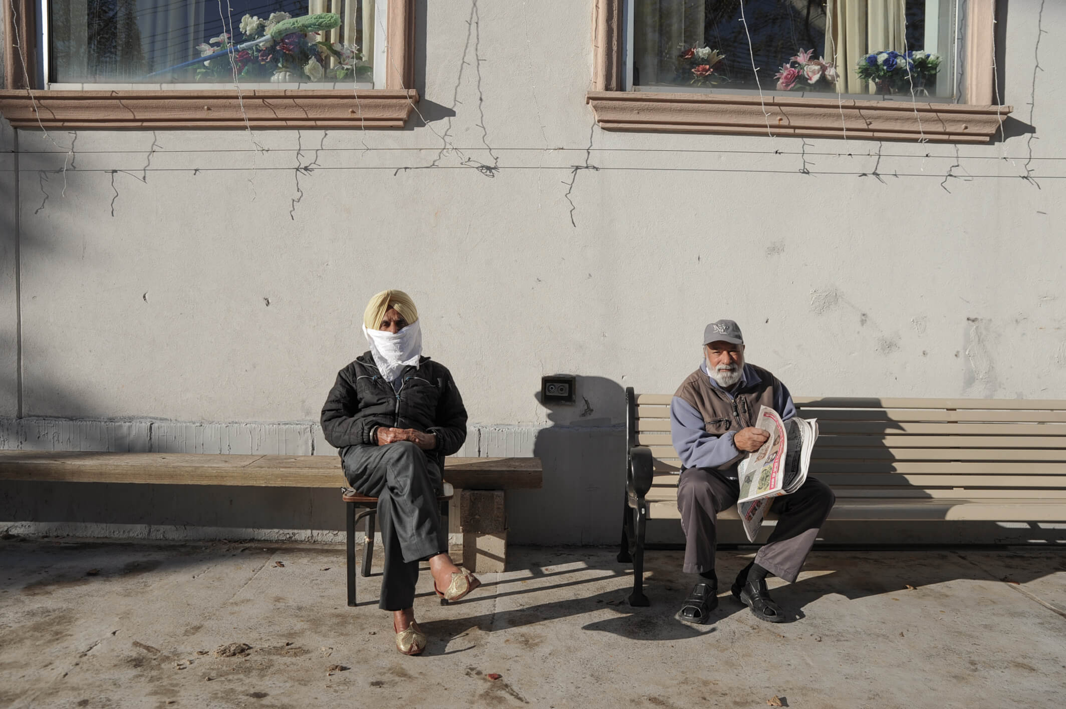 People sitting outside The Sikh Cultural Society of New York's Gurudwara