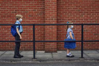 Children going to school wearing face masks