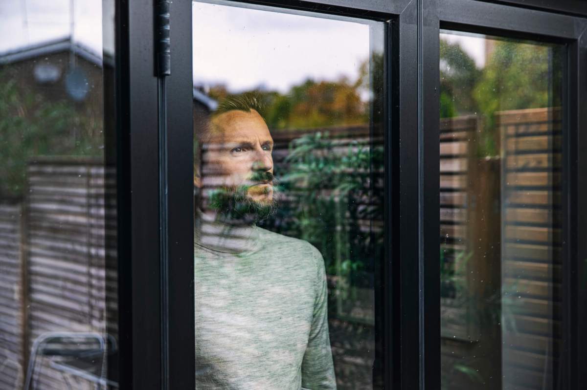 Man looking through window