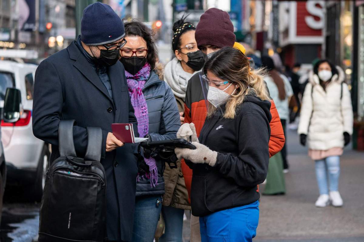 People queue at a popup COVID-19 testing site in New York