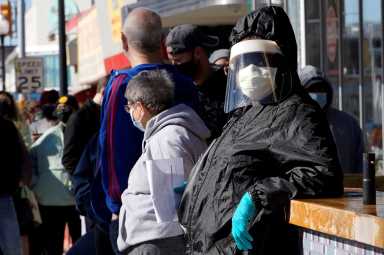 People wait in line to be tested for COVID-19 at the Tower Theatre in Oklahoma City