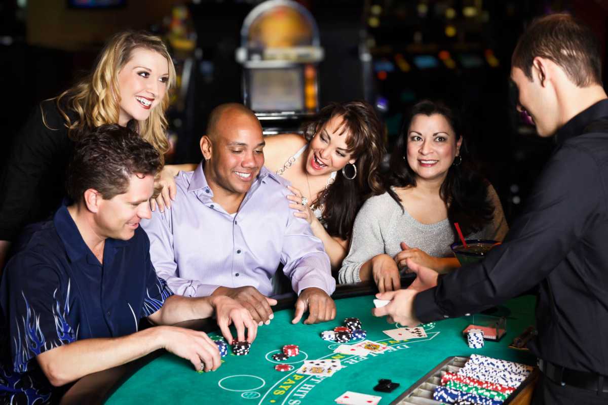 Diverse Group of People Playing Blackjack In a Casino