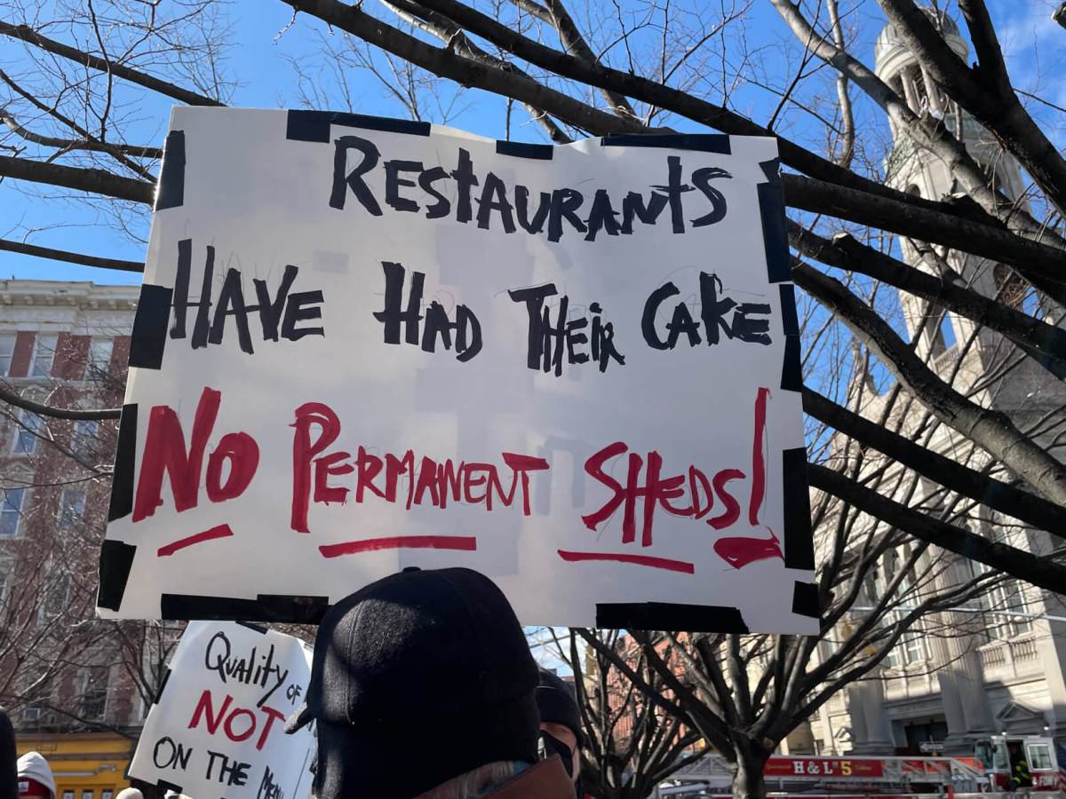 Father Demo Sq. protest sign.