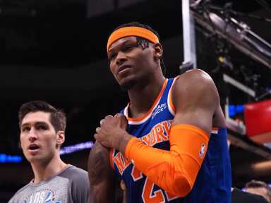 Cam Reddish holds his shoulder after suffering an injury against the Sacramento Kings on March 7.