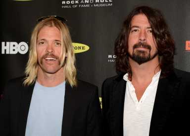 FILE PHOTO: Taylor Hawkins and Dave Grohl of the Foo Fighters arrive at the 2013 Rock and Roll Hall of Fame induction ceremony in Los Angeles