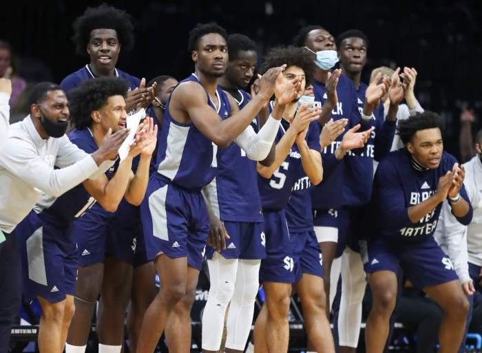 The Saint Peter's bench reacts in the first half against Purdue.