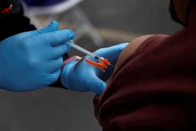 FILE PHOTO: Coronavirus disease (COVID-19) vaccine booster, at the First African Episcopal Church in Los Angeles, California
