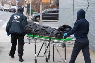 Medical examiner take away body of woman in SoHo