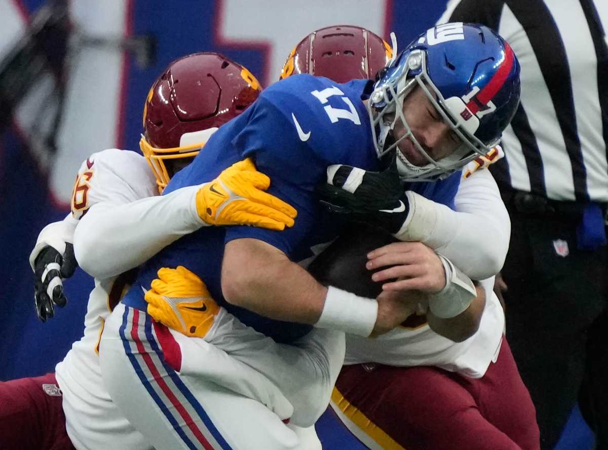 Giants quarterback Jake Fromm gets sacked by Washington's James Smith-Williams.