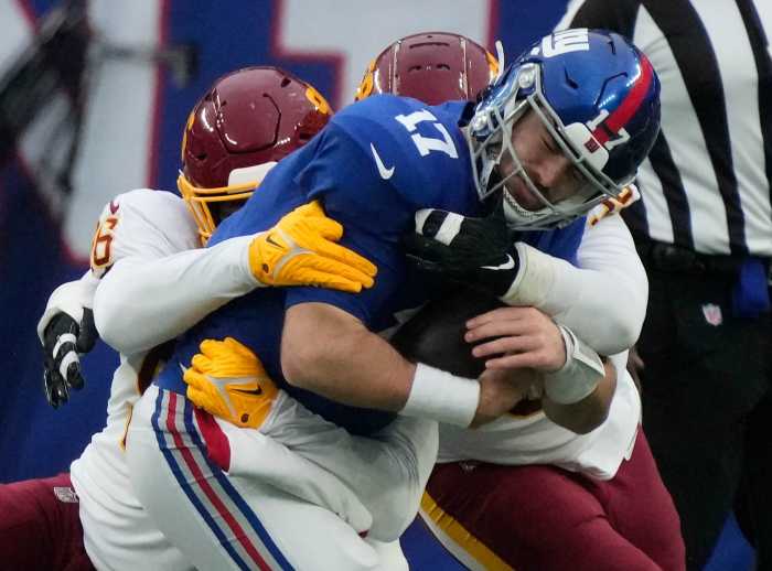Giants quarterback Jake Fromm gets sacked by Washington's James Smith-Williams.