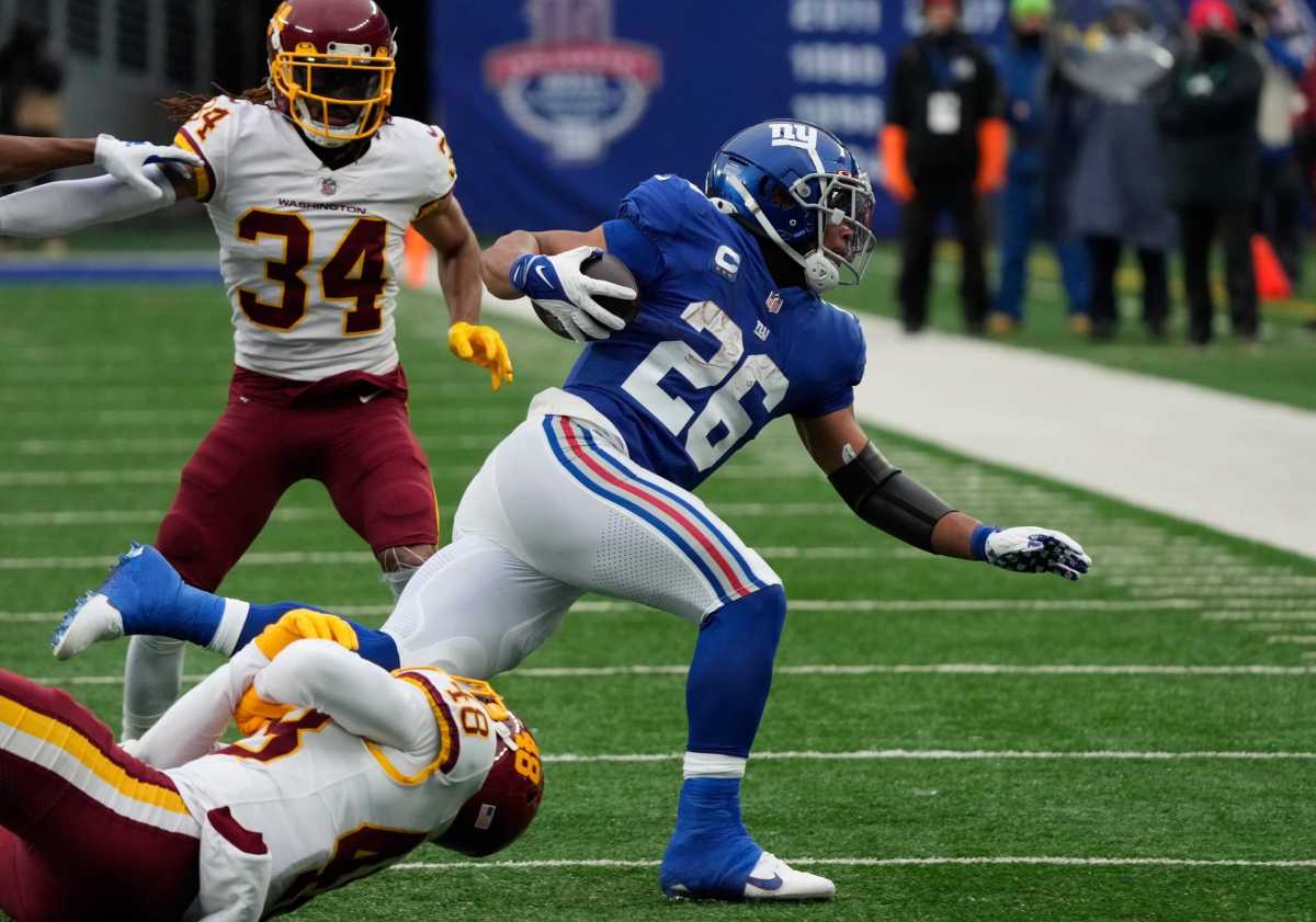 Giants running back Saquon Barkley is tackled against the Washington Football Team.