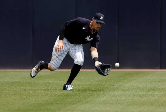 Yankees right fielder Aaron Judge fields a ball during the fourth inning against the Philadelphia Phillies during spring training.