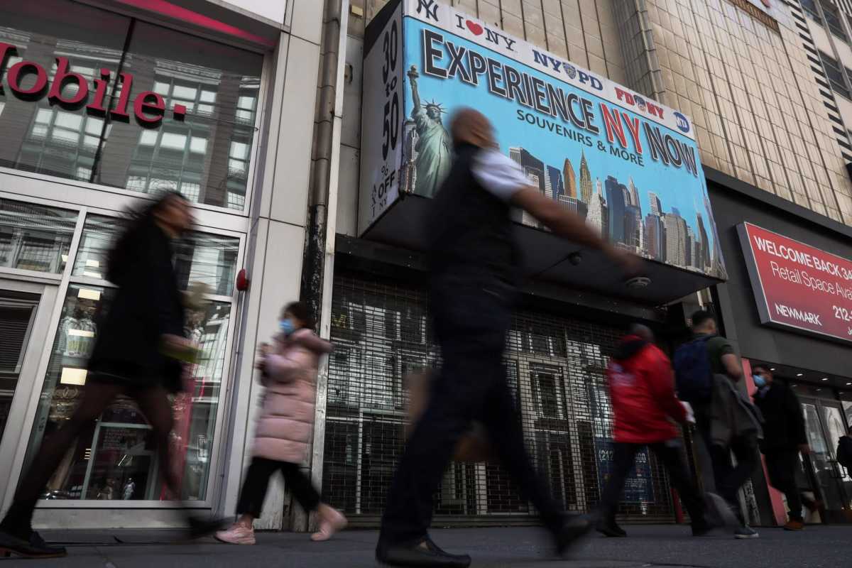 People walk along 34th street in New York City