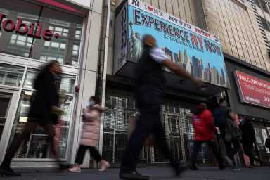 People walk along 34th street in New York City