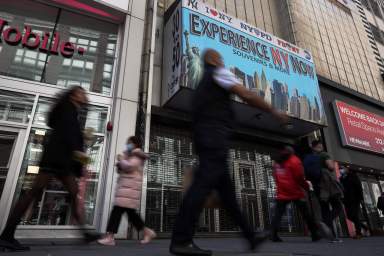 People walk along 34th street in New York City