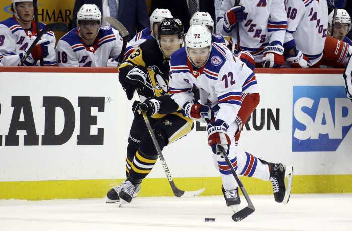 Rangers center Filip Chytil moves the puck against Pittsburgh Penguins left wing Danton Heinen during the loss on Saturday.