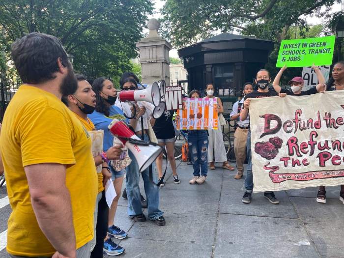 Protestors rally against DOE school budget cuts.