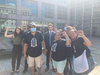 Tenants and city officials rally to slow eviction court outside of the Queens Housing Court.