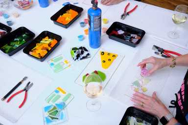 An overhead shot of a glass making class