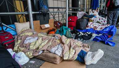 Asylum seekers sleep outside of the Watson Hotel