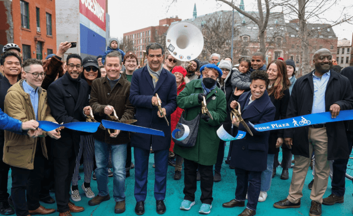 Officials gather to cut the ribbon on the new Underhill Plaza