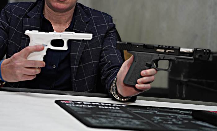 Police officer holds up ghost guns