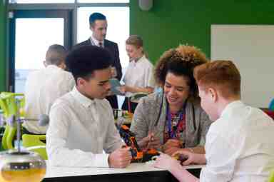 Teacher with students in charter school classroom