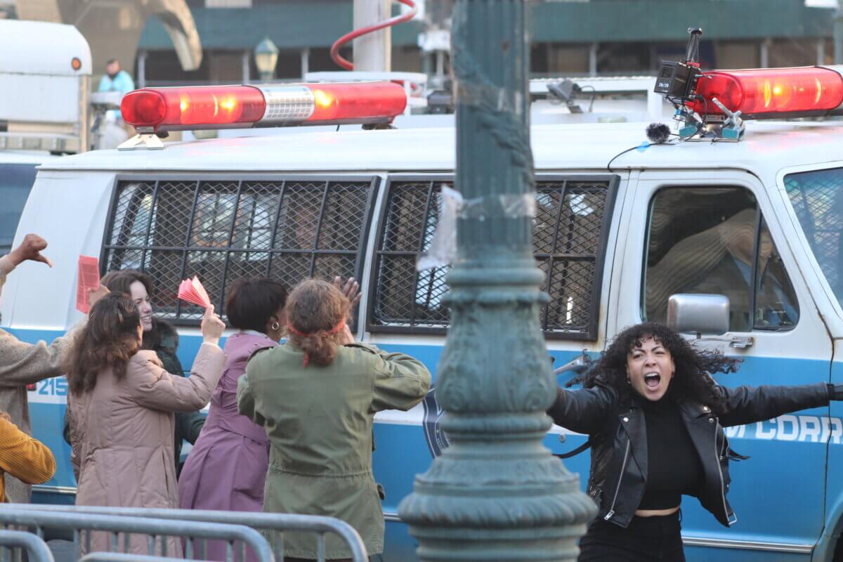 Crowds descend on a police van holding the Joker, on the set of Joker 2, "Joker: Folie à Deux" (Photo by Michael Dorgan)