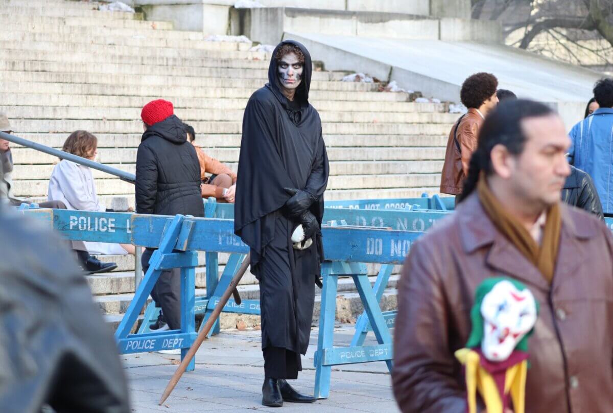 A man in costume on the set of Joker 2, "Joker: Folie à Deux" (Photo by Michael Dorgan)