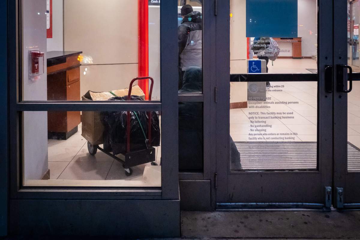 Customer uses ATM at bank in Chinatown