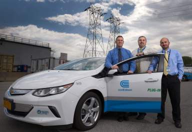 William Tesi, Fortunate Gufino and Joseph Venezia, from transportation, stand by the new Chevy Volt Electric Hybrid in Astoria, which will become part of the Con Edison fleet