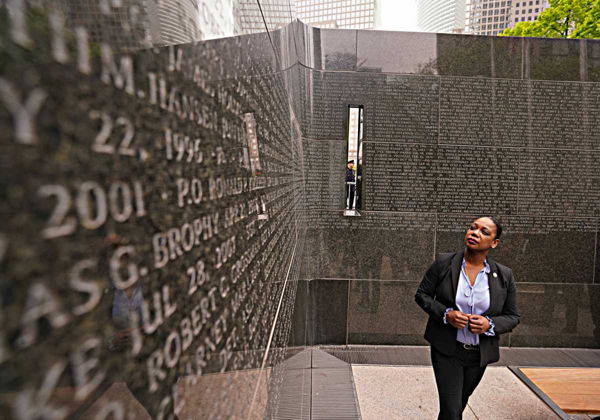 Police Commissioner Keechant Sewell looks over the expanded memorial wall in Battery Park City.