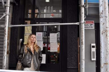 Rachel Bryant, a former tenant of 111 Mott Street, stands outside of the building she was forced to leave when the building facade fell apart.