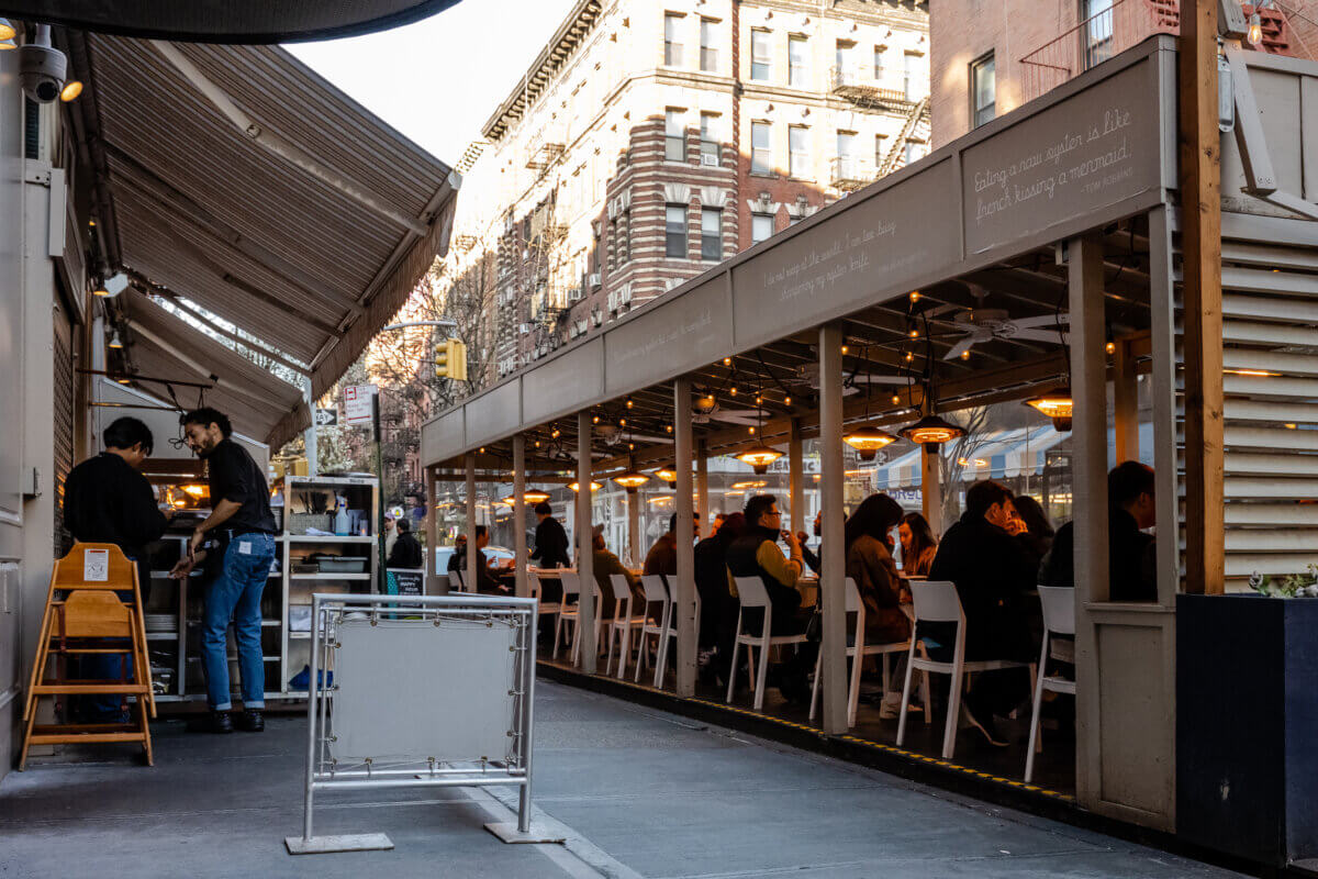 The dining shed of Mermaid's Oyster Bar on MacDougal Street filled with customers