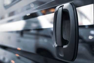 closeup of black car side sliding door handle