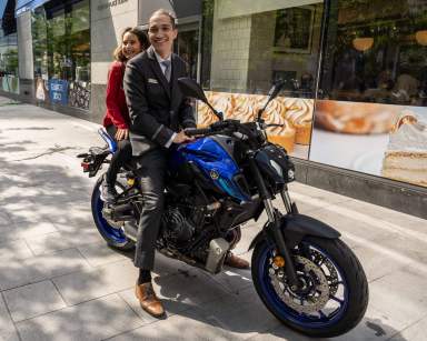 Dylan Leder and doorman Nazar on the new motorcycle she raised funds to purchase for him